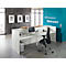 White reception desk in modern office. Behind, a wall with a welcome greeting in German and English, plus three framed pictures.