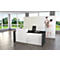 Modern reception desk in white and black. Blurred people in the background.