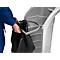 Person puts a black garbage bag into a gray trash can. The bin has a gray handle.