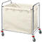 Laundry cart with a cream-colored fabric bag and metal frame on wheels. Bag secured with metal clips.