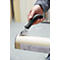 Person securing paper roll with stapler. Hand holds black handle and silver stapling tool.