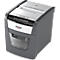 Gray paper shredder with white top, 'Rexel' lettering, shredded paper visible.