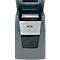 Grey paper shredder with open flap. Papers are shredded. Rexel logo.