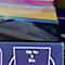 Close-up of an edge with the text "Up to à Bis" in white on a blue background. Above are layers of color.