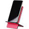 A smartphone in a pink phone holder. The phone's screen is black.