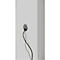 A gray cable inlet with black cables protruding from a white wall.
