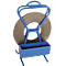 Blue tape stand with a gray metal roll. The carrying handle transitions to the holder at the top.