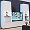 White living room unit with TV. A safe is in a compartment. Decorative figures on the shelves.