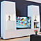 White living room wall unit with TV, art objects and safe. A dark wall in the background.