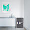 Gray safe on white wall. Above a metal console hangs a picture with green zigzag lines.