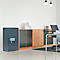 Blue safe with white handle next to wooden cabinets in an office.