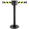 A retractable belt stanchion with yellow and black striped bands. On a black base with a dark post and top housing.