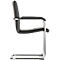 Side view of a black cantilever chair. Chrome frame, padded seat, backrest and armrests.