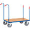 Blue cart with brown loading surface and red handles. Four wheels.