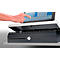 A hand touches the screen of a cash register. The screen displays numbers and symbols. Below is a drawer.