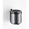 Gray, wall-mounted trash can. The lid has a hole, below is a black ring. On a white background.