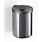 Gray, cylindrical trash can, attached to the wall. Lid with a circular opening.