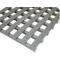 Grey plastic mat with a grid pattern. The mat has a rough surface and is photographed diagonally from above.