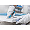 Person cutting an insulation board with a blue cutter, wearing white gloves.