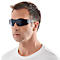 Man wearing sunglasses, in profile against a white background.
