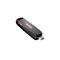 Une clé USB-C grise SanDisk, en diagonale de en haut à gauche à en bas à droite sur fond blanc.