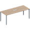 A rectangular, light brown conference table with silver legs and a recessed silver plate.