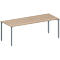 Rectangular table with beige wooden top and silver legs.