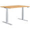 A height-adjustable desk with a light brown tabletop and silver legs.