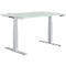An adjustable height desk against a white backdrop. The tabletop is light gray, and the legs and frame are silver.