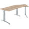 A light-colored, height-adjustable desk with a curved tabletop on silver legs.