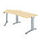 An ergonomic, height-adjustable desk with a light brown table top and silver legs.