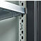 Close-up of a metallic shelving system. A silver shelf is held by a metal bracket, details.