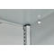Close-up of a grey metal construction. The corner of a housing with shelf brackets and lighting is visible.