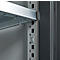 Close-up of a metal shelf. The silver shelves are attached to a gray vertical metal post with a bracket.
