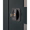 Close-up of a dark cabinet lock with key. The key is inserted into the lock.