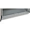 Close-up of a gray metal shelf in a cabinet, perforated with small holes.