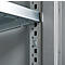 Close-up of a metal shelf mounted in a light gray cabinet. The gray metal construction shows a shelf bracket.