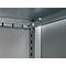 Corner of a metal shelf construction. Gray-silver angles and struts, some with hooks. Light wall in the background.