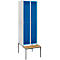 A white locker with two blue doors and a wooden bench.