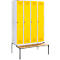 A locker with four yellow doors and a wooden bench in front.