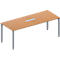 A rectangular, light brown conference table with silver legs and a silver recess in the middle.