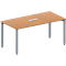 A rectangular table with a light brown table top, silver legs and a silver recess in the middle.