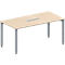 Rectangular, light brown table with silver-gray legs. There is a rectangular recess in the table top.