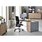 A modern corner desk with office chair in a bright office. On the desk are a monitor, plants and office supplies.