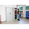 A woman stands by an open tool cabinet. Tools and materials are stored in the cabinet.