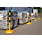 Yellow and black barrier posts with chain in front of stacks of goods on pallets.