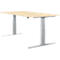 A height-adjustable desk. Light wood top on silver, T-shaped legs. Control for height adjustment.