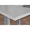Close-up of a light grey table top with white edge, in the corner area. Underneath is a table leg.