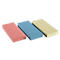 Three rectangular, colored blocks: pink, light blue, and beige. Each has two holes. On a white background.