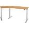 A light brown corner desk with silver height-adjustable legs. It stands against a white background.